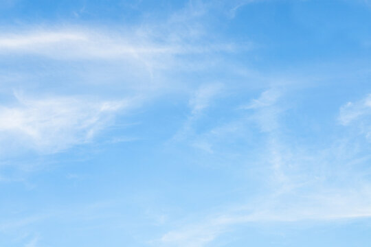 blue sky with light clouds illuminated by the afternoon sun