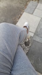 Close-up od a person in gray sweatpants relaxing outdoors © Ljiljana