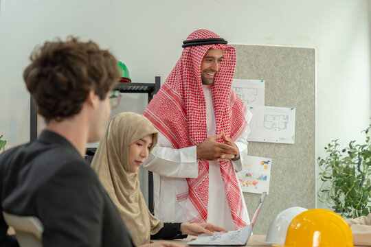 Diverse architectural team discussing plans in the office