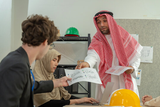 Arab engineer sharing construction documents with colleagues
