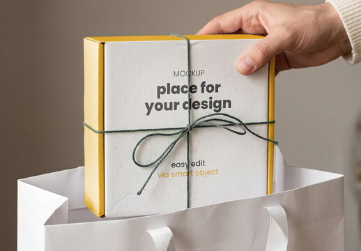 Hand Lifting Present Box from Bag Mockup