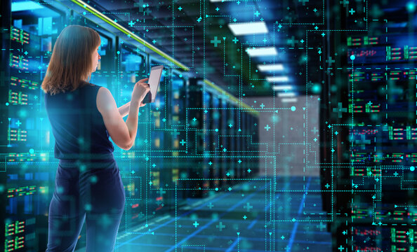 Data center management. IT specialist monitors server infrastructure with a tablet for network control, data processing, cloud computing and cybersecurity.
