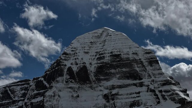 Close-up detailed view of holy Mount Kailash snow peak against bright blue Sky.