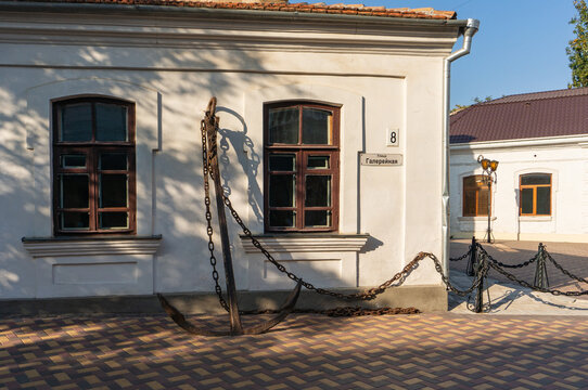 White building of Alexander Green Literary Memorial Museum with two arched windows. Oversized anchor adorns its facade, while chains stretch across front. Feodosia, Crimea &ndash; October 14, 2014.