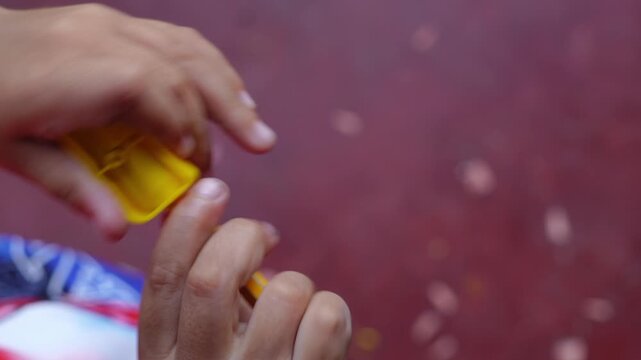 Child's hands sharpening a yellow colored pencil with a plastic sharpener in a close up creative activity