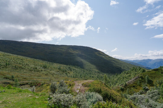 Vast green mountain landscape with rolling hills and valleys in rural Norway