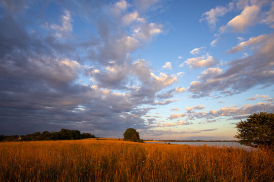 Dramatic morning light over the rolling coastal hills and fields at Stavns Fjord on Sams&oslash; island, Denmark