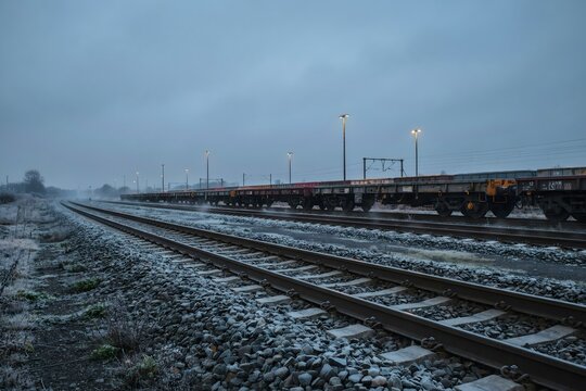 Parallel tracks and rolling stock at a rail freight depot &ndash; Perfect for supply chain reports, rail travel, or industrial backgrounds