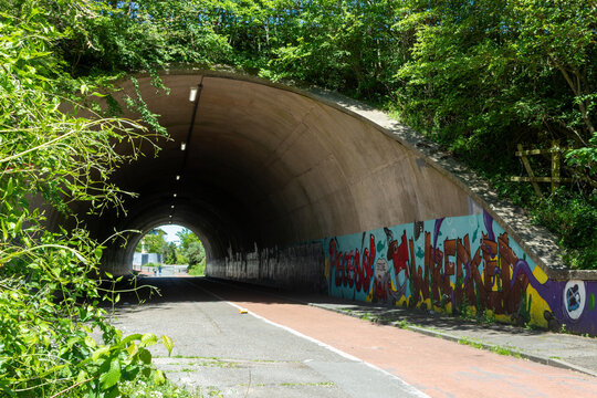 Concrete pedestrian underpass beneath the M48 motorway with vibrant street art in Thornwell Chepstow