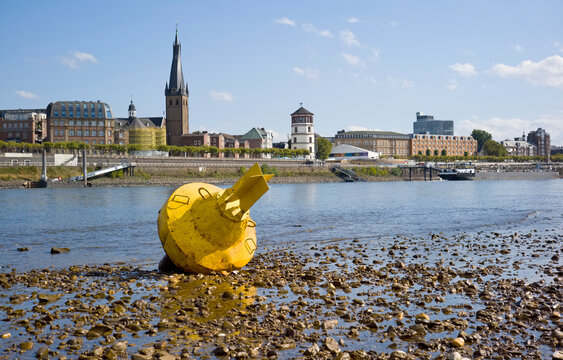 D&uuml;sseldorf, Germany, Low stream gauge of rhine river.Due to heat, drought, climate change and global warming plants are conquering the riverbed and ships can only operate with reduced cargo