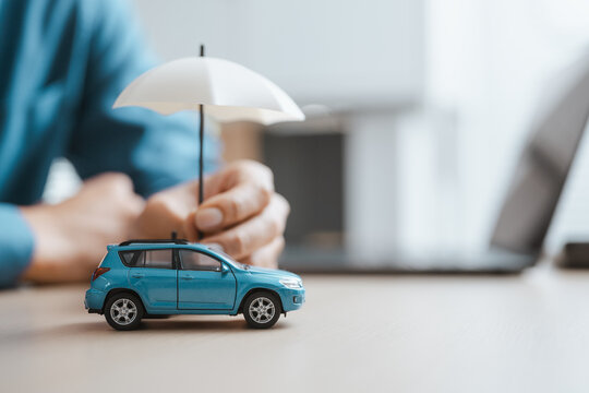 A hand shields a small blue model beneath an umbrella as insurance relates car needs to an agent policy that can protect, while insurance symbols connect car needs to an agent policy made to protect.