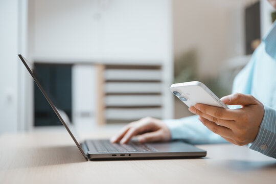 One hand holds a phone near a laptop as customer support suggests possible live access to chat online, while customer needs frame support through live access for chat online beside the open computer.