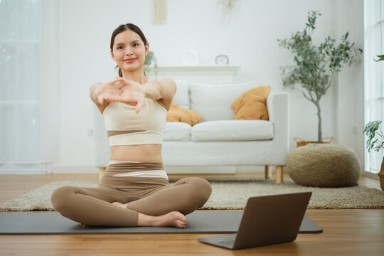 A seated adult reaches toward a laptop as lifestyle for women connects wellness and wellbeing to a woman, then lifestyle for women supports wellness and wellbeing as the woman holds a seated stretch.