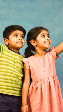 Two children standing side by side, possibly siblings or friends