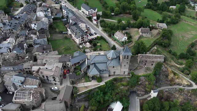 Aerial view of the Torla-Ordesa village and Ordesa-Monte Perdido National Park in the Spanish Pyrenees mountains. Medieval buildings and the Church of San Salvador in Torla-Ordesa, Huesca, Spain.