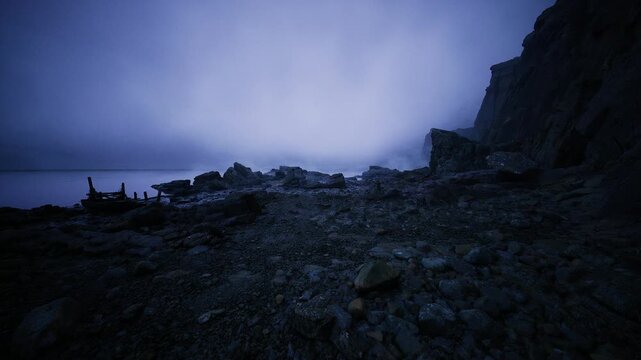 misty pebble beach under indigo sky, scattered boulders and damp cliffs, low tide pools and textured rock, cinematic fieldwork aesthetic for editorial
