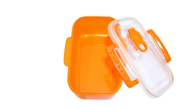 Empty orange airtight plastic food container with opened clear lid isolated	