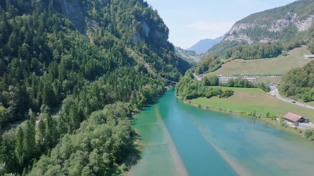 Clear Water Winding Through a Green Alpine Valley in Switzerland
