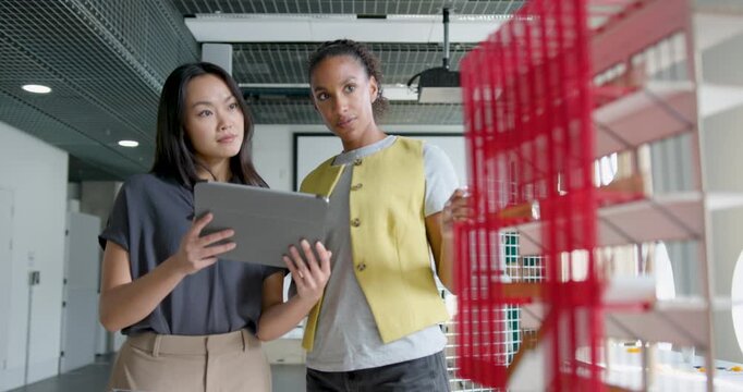Two Women Architects Collaborating in Modern Office Space