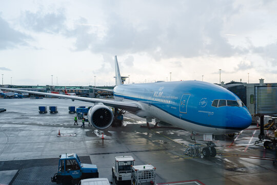 August 21, 2026, Amsterdam, Netherlands - KLM Royal Dutch Airlines Boeing 777 aircraft parked at Schiphol Airport gate with ground crew