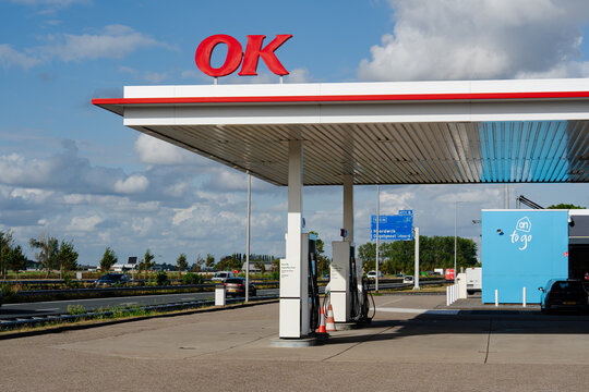 August 21, 2026, Amsterdam, Netherlands - OK gas station with 'ah to go' kiosk next to a highway