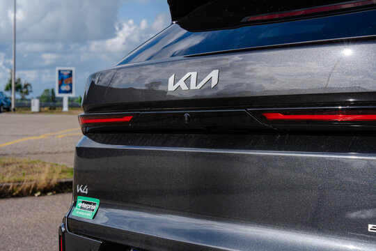 August 21, 2026, Amsterdam, Netherlands - Rear view of a dark grey Kia K4 car with Enterprise rental sticker