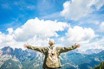 Fototapeta na wymiar Happy hiker with arms up stading on top of the mountain - Successful and sport life style concept
