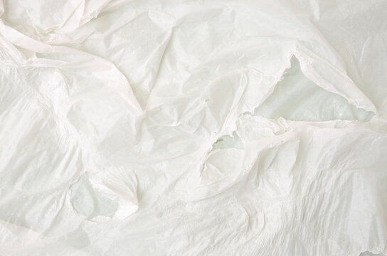 Torn White Wrinkled Plastic Material Texture with Layered Folds and Rough Edges