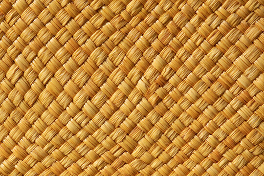 Close-up of golden woven straw texture for background