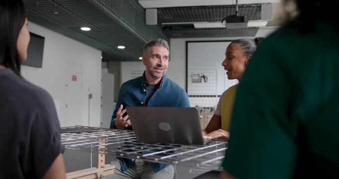 Team Discussing and Collaborating in Business Meeting Around a Table in Modern Office