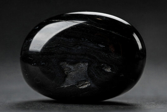 Polished Black Obsidian Stone Sphere on Dark Background