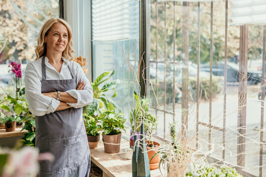 Woman florist small business owner standing in flower shop