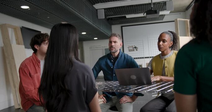 Team Discussing and Collaborating in Business Meeting Around a Table in Modern Office