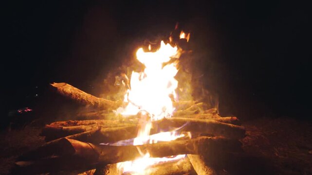 Bright Bonfire Burning with Flames and Smoke in Night Darkness