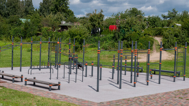 Empty Outdoor Calisthenics and Street Workout Park with Grey and Orange Steel Frames &mdash; Concept: Free Public Fitness Infrastructure, Municipal Investment in Health, Urban Recreation Facilities