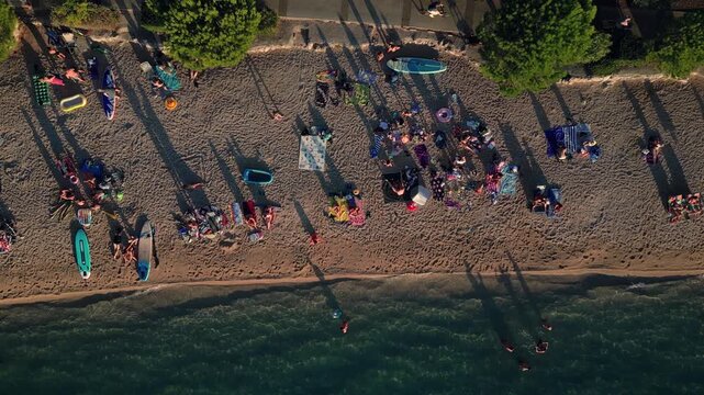 Tracking aerial shot right to left of Kovacine camp beach, town Cres, island Cres, Croatia