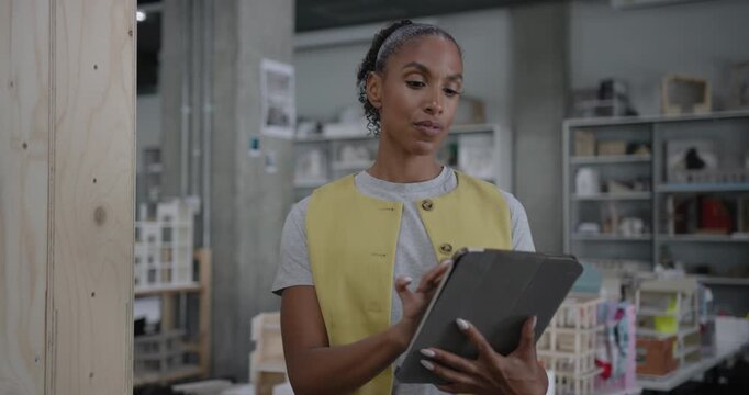 Focused Female Architect at Work with Digital tablet in Modern Office