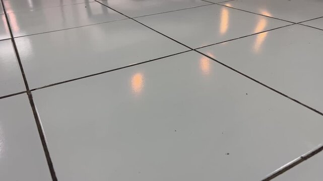 Shiny White Ceramic Floor Grid with Parallel Light Reflections