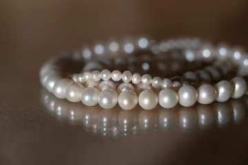 Elegant Pearl Necklace on Dark background, Glass Surface with Reflection. © Elina Leonova