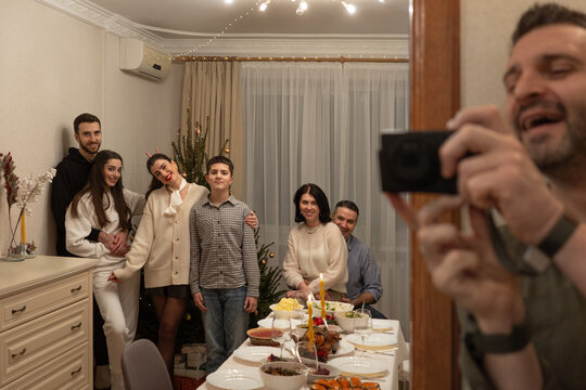 Family Posing for Christmas Photo at Home