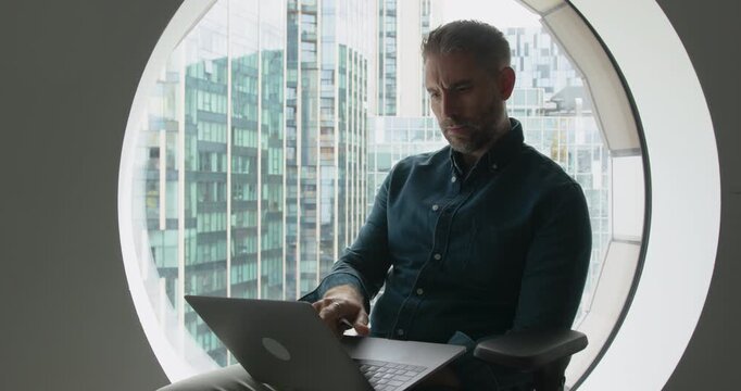 Focused Professional Worked on Laptop in Office