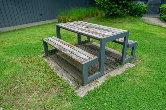 Wooden Bench in park,chairs and table in countryside,outdoor seating cafe or restaurant,Neat paved patio with sitting area,small garden in farm.
