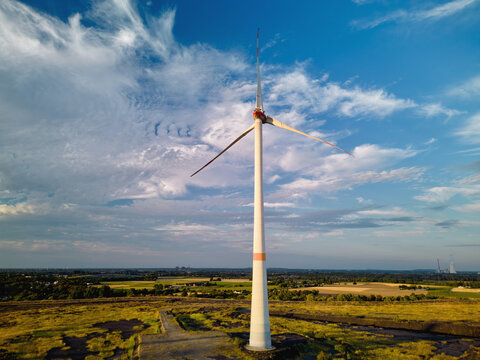 Wind Turbine Standing in Open Field During Daytime