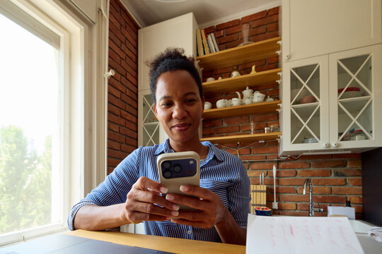 Woman works from home, checking her phone