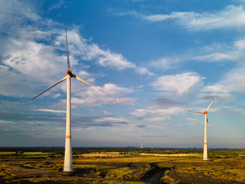Wind Turbines Stand Tall in Open Field During the Afternoon
