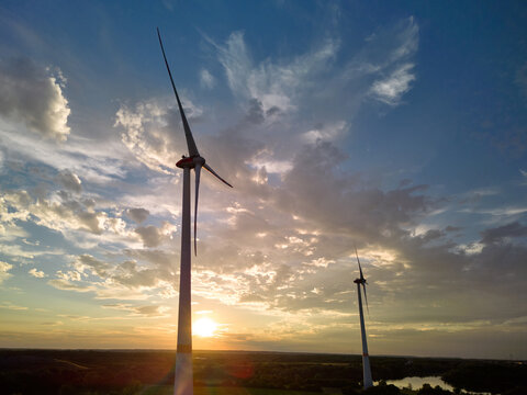 Sunset Over Wind Turbines With Clouds in the Sky