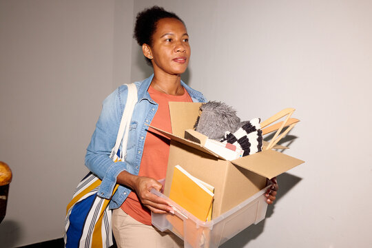 Woman carries a box of things