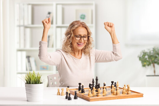 Mature woman winnign a chess game
