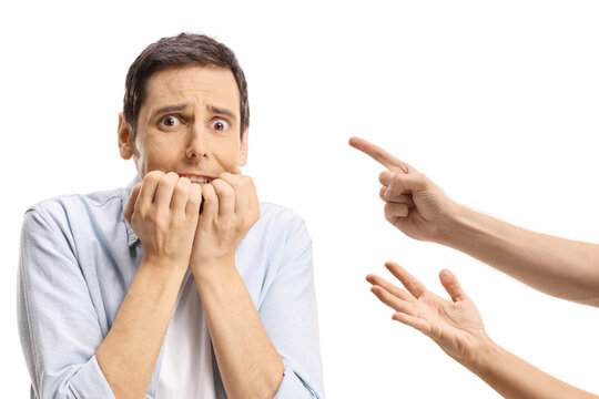 Fingers reprimanding a scared young man biting his fingernails