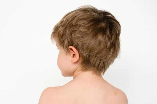 Young child facing away wall